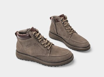 Taupefärgade herrboots i mocka med brunt skaftkant och profilerad sula, frilagda mot vit bakgrund. | © Gabor Shoes GmbH, Tyskland