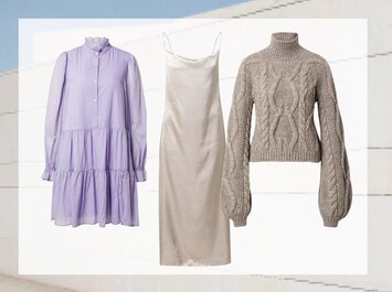 Une robe-chemise mauve à manches longues, une élégante robe en satin beige à fines bretelles et un pull gris en maille avec col roulé et motif torsadé sont disposés côte à côte sur un fond clair. | © aboutyou.de 
