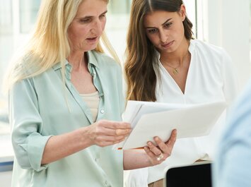 "Two people look at documents together. " | © Gabor Shoes GmbH, Germany